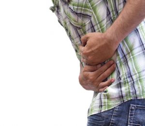 a man holds his stomach in pain.