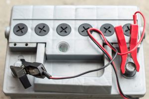 An electrical box with black and red wires coming out of it.