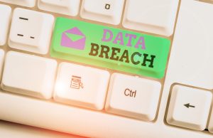 A keyboard with a green tab spelling out the words 'data breach'. 