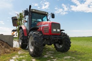 A large red tractor on a field.