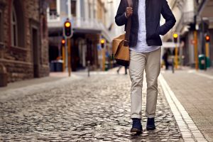 Someone walking down a cobblestone street.