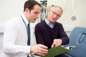 A GP showing a patient their test results.