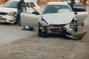 Accident scene of two badly damaged cars.