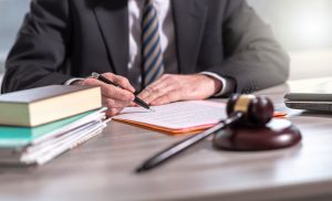 A solicitor sitting at his desk using a road accident compensation calculator for a claim.