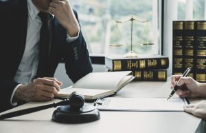 A medical negligence solicitor sat at their desk with a gavel.