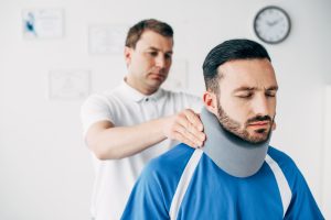 A man has treatment for a neck injury.